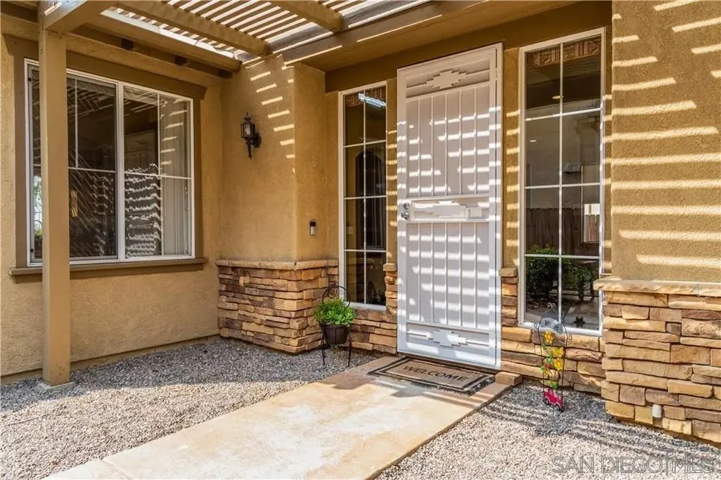 531 Poets Square Fallbrook, CA 92028 - Photo 3 of 19 a front view of a house with a yard