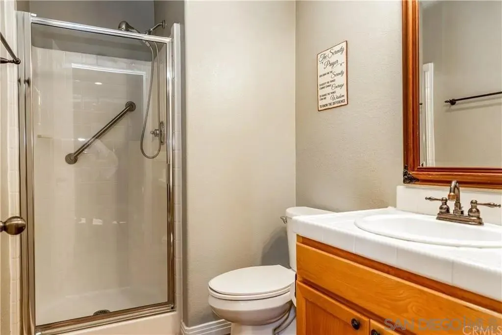 531 Poets Square Fallbrook, CA 92028 - Photo 10 of 19 a bathroom with a granite countertop toilet sink and shower