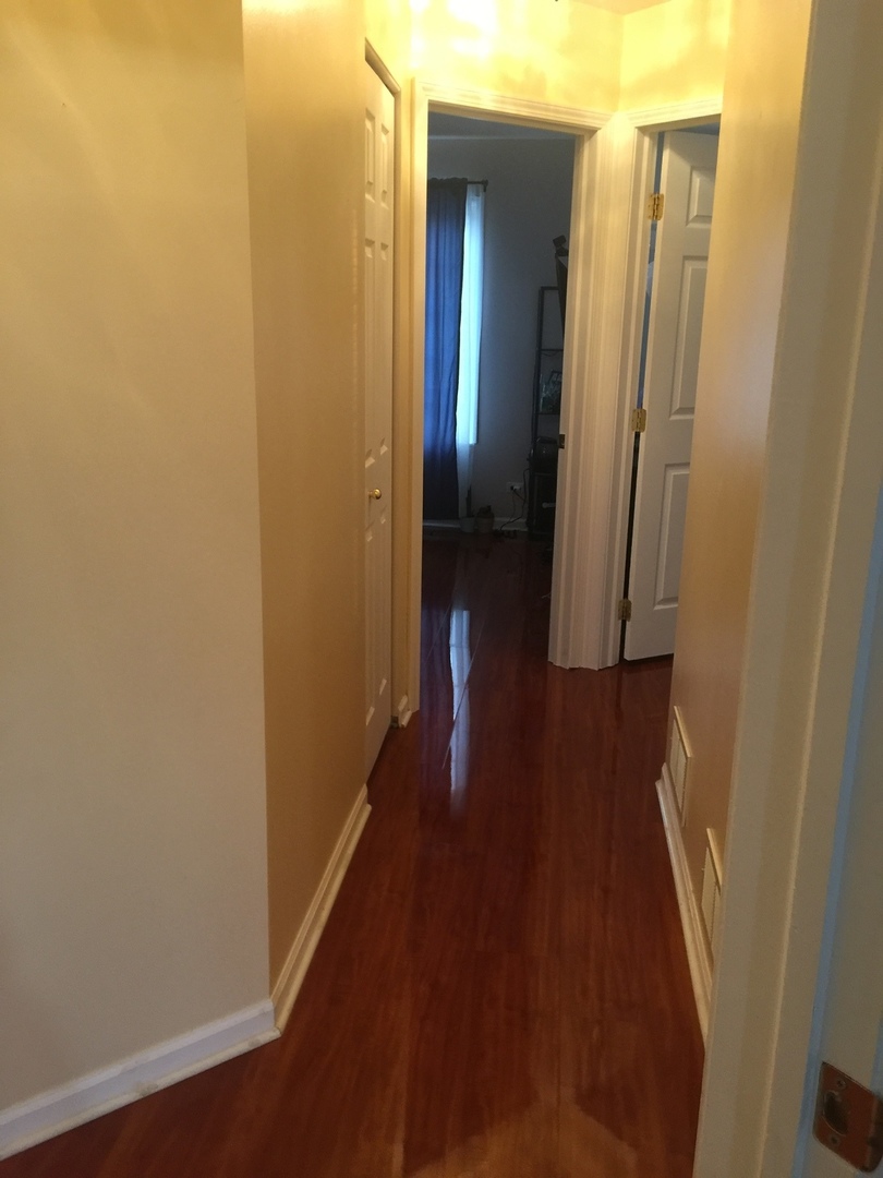 3493 Ravinia Circle, Unit 3493 Aurora, IL 60504 - Photo 14 of 18 a view of a hallway with wooden floor