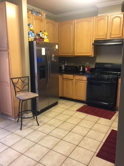 3493 Ravinia Circle, Unit 3493 Aurora, IL 60504 - Photo 5 of 18 a kitchen with stainless steel appliances granite countertop a stove a sink and a refrigerator