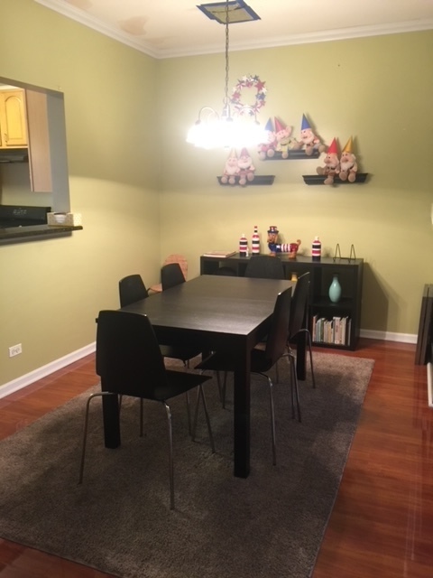 3493 Ravinia Circle, Unit 3493 Aurora, IL 60504 - Photo 8 of 18 a view of a dining room with furniture and wooden floor