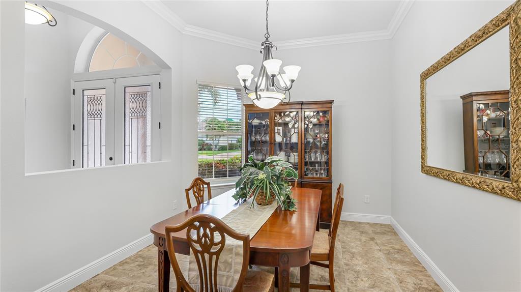 5621 Rock Dove Drive Sarasota, FL 34241 - Photo 12 of 49 a view of a dining room with furniture a chandelier and wooden floor