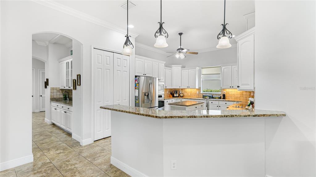 5621 Rock Dove Drive Sarasota, FL 34241 - Photo 14 of 49 a view of a kitchen with center island and stainless steel appliances