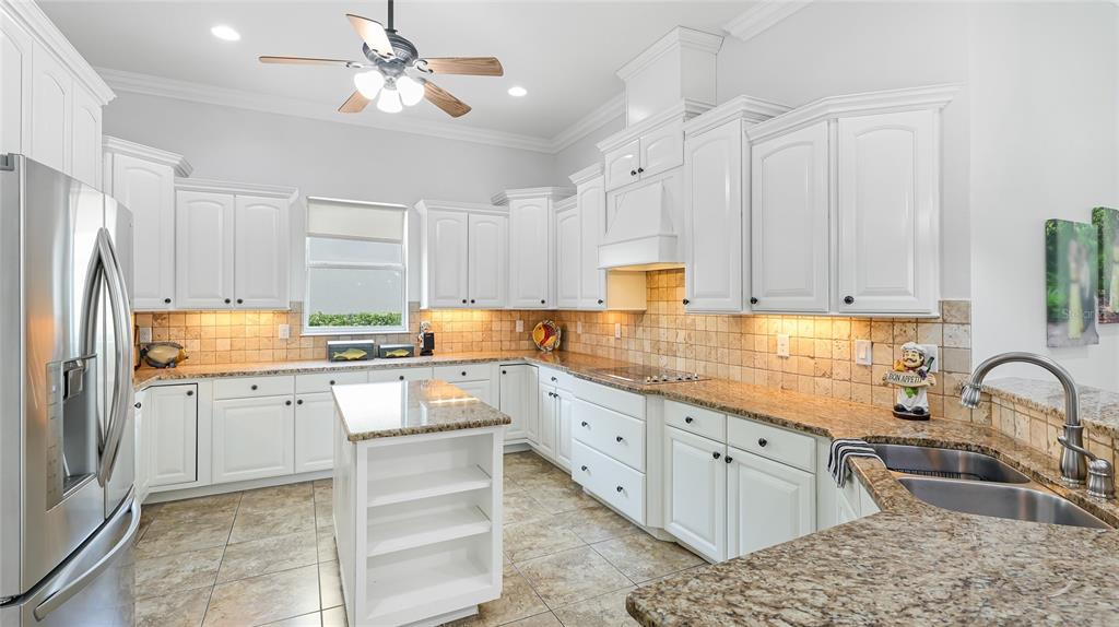 5621 Rock Dove Drive Sarasota, FL 34241 - Photo 15 of 49 a kitchen with granite countertop a sink stainless steel appliances and cabinets