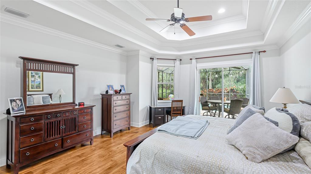 5621 Rock Dove Drive Sarasota, FL 34241 - Photo 20 of 49 a bedroom with a bed and large windows