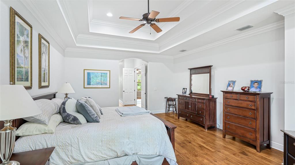 5621 Rock Dove Drive Sarasota, FL 34241 - Photo 21 of 49 a bedroom with a bed and a chandelier