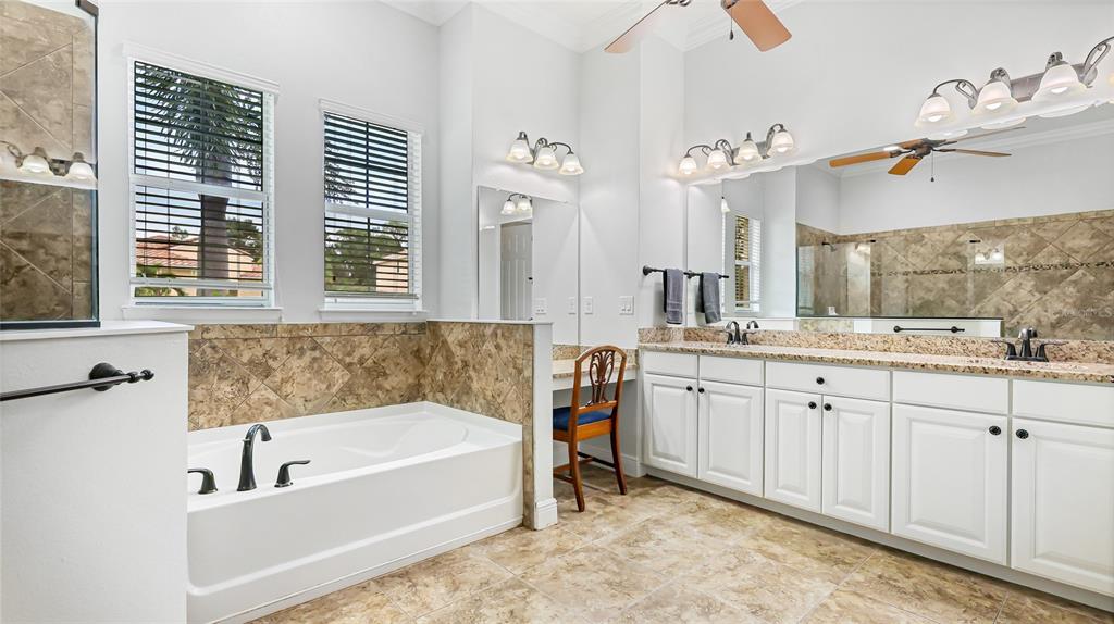 5621 Rock Dove Drive Sarasota, FL 34241 - Photo 22 of 49 a bathroom with a tub sink and mirror