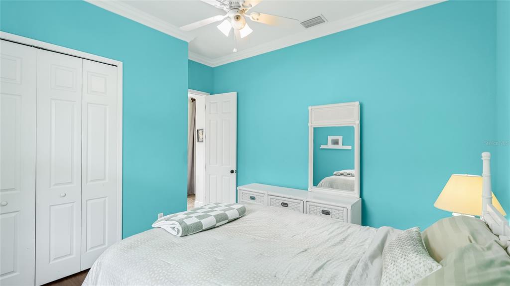 5621 Rock Dove Drive Sarasota, FL 34241 - Photo 26 of 49 a bedroom with a bed and a chandelier