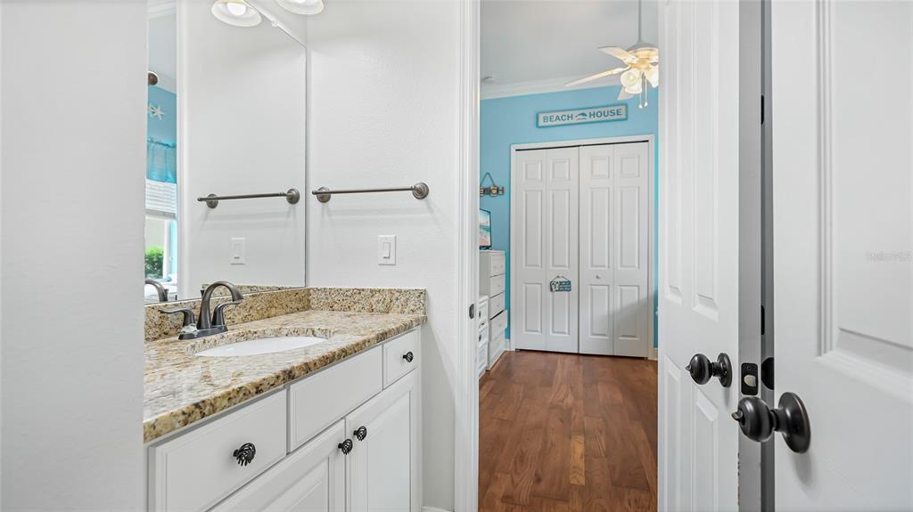 5621 Rock Dove Drive Sarasota, FL 34241 - Photo 30 of 49 a bathroom with a granite countertop sink a mirror and shower