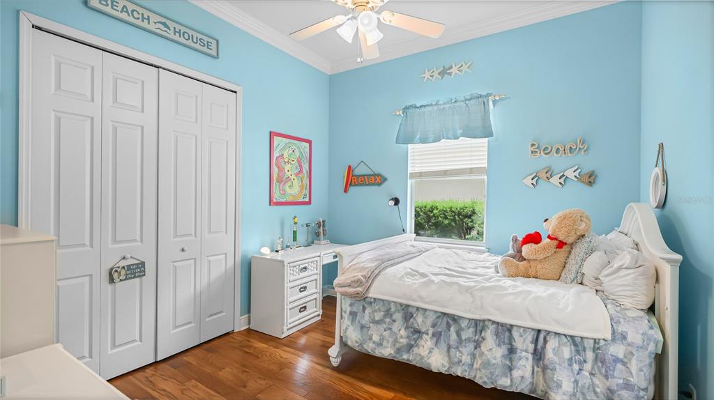 5621 Rock Dove Drive Sarasota, FL 34241 - Photo 32 of 49 a bedroom with a bed and a chandelier