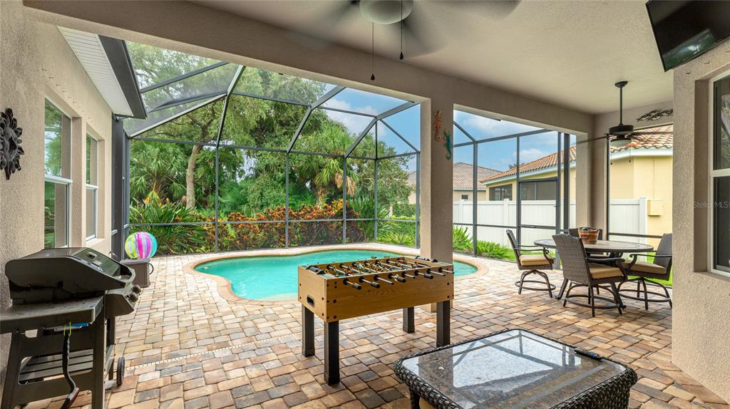 5621 Rock Dove Drive Sarasota, FL 34241 - Photo 38 of 49 a living room with patio furniture and a floor to ceiling window