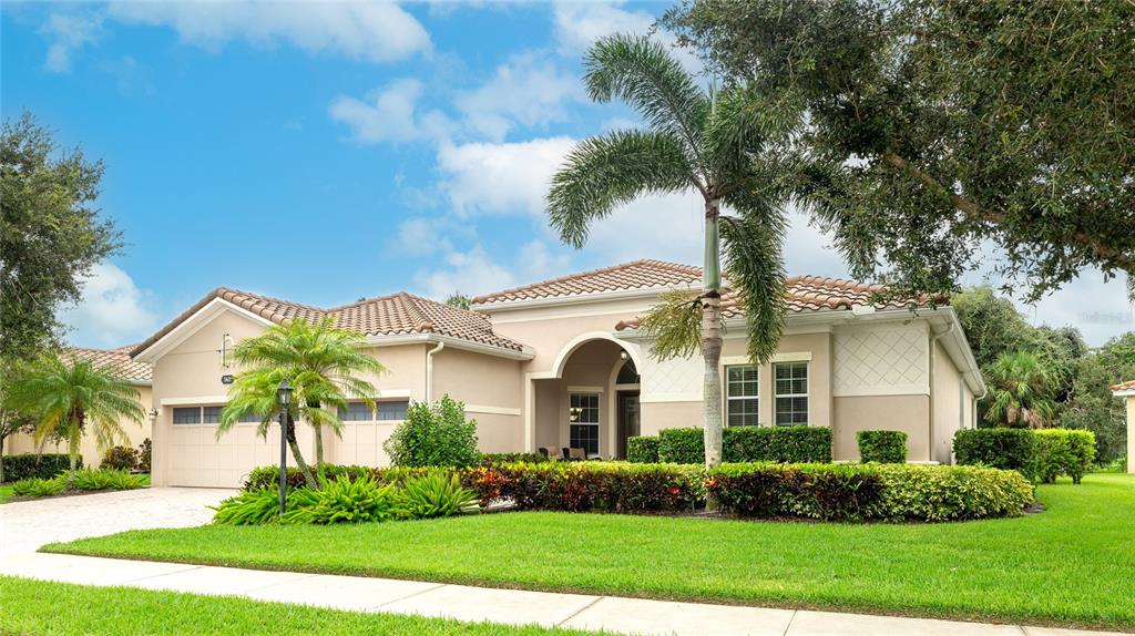 5621 Rock Dove Drive Sarasota, FL 34241 - Photo 45 of 49 a front view of a house with a garden and plants