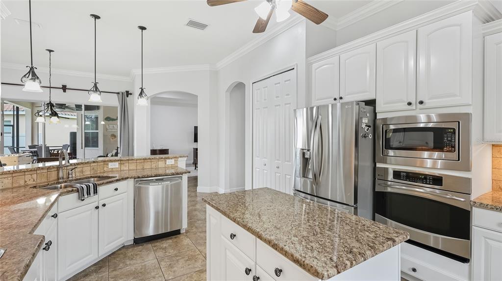 5621 Rock Dove Drive Sarasota, FL 34241 - Photo 7 of 49 a kitchen with stainless steel appliances granite countertop a sink a stove and refrigerator