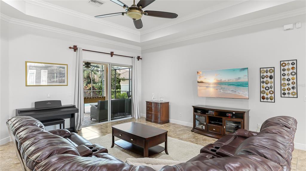 5621 Rock Dove Drive Sarasota, FL 34241 - Photo 10 of 49 a living room with furniture a fireplace and a flat screen tv