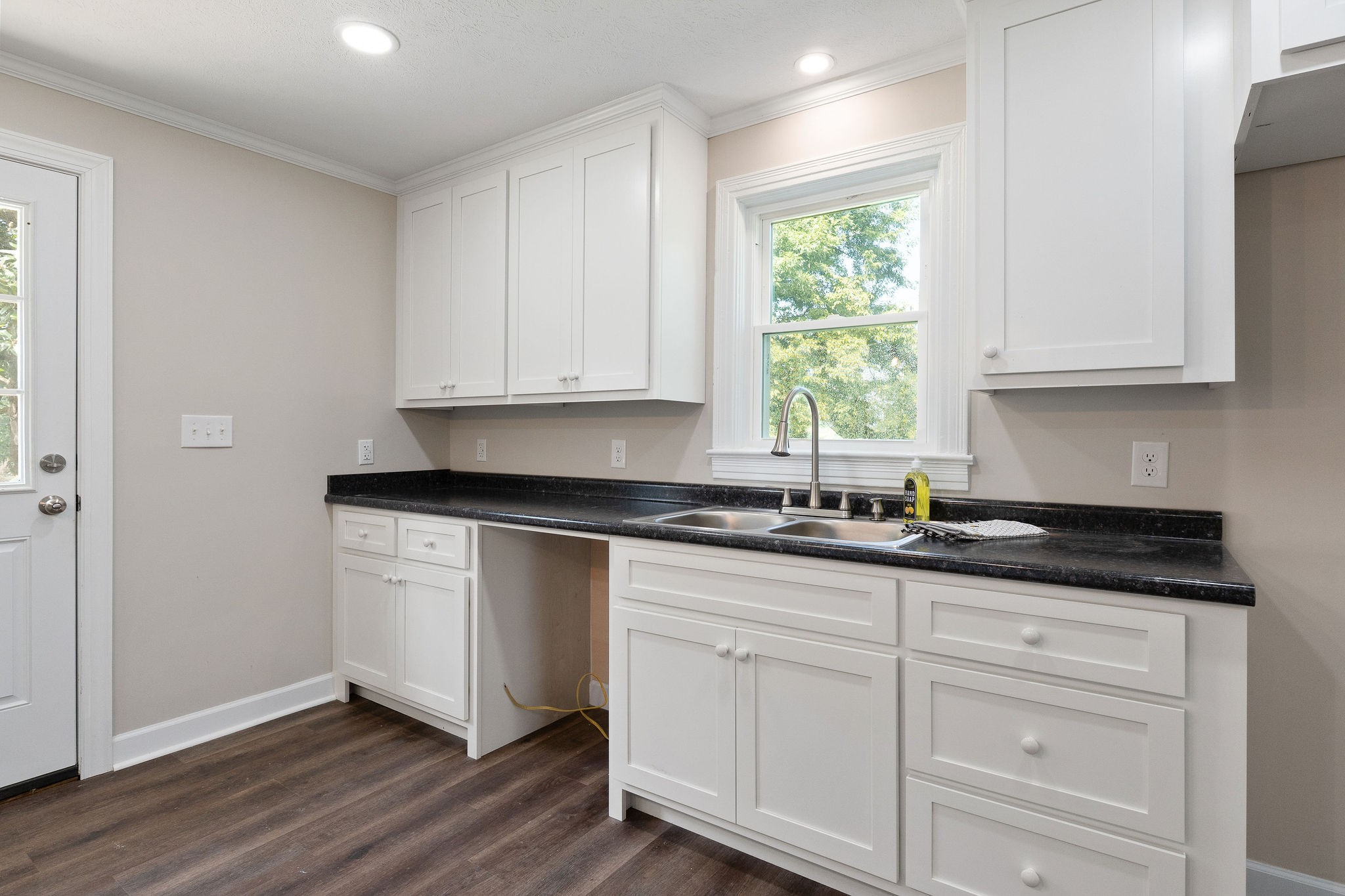 218 Roosevelt Road McMinnville, TN 37110 - Photo 15 of 31 a kitchen with granite countertop white cabinets white appliances and a sink
