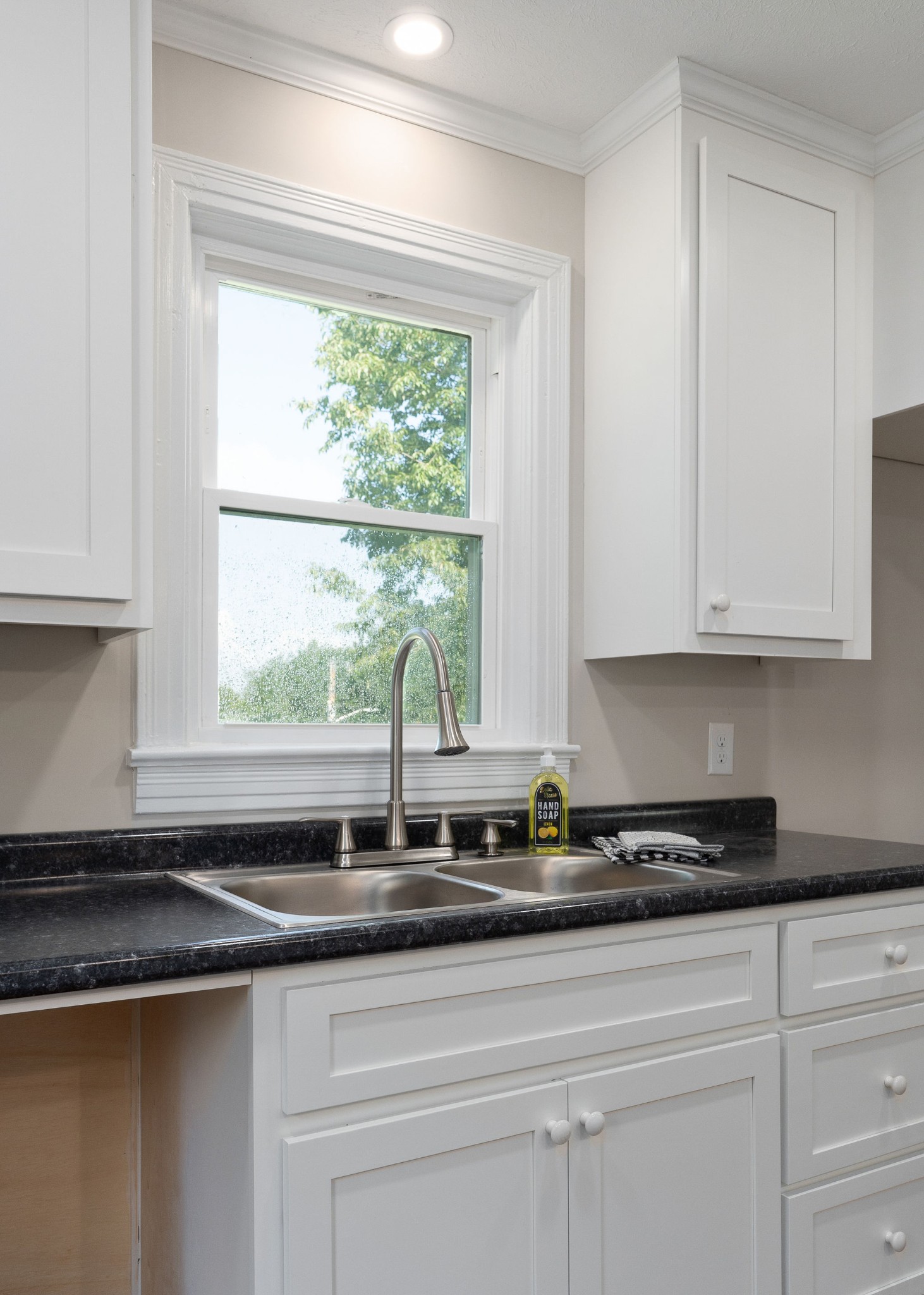 218 Roosevelt Road McMinnville, TN 37110 - Photo 16 of 31 a sink with a granite countertop a sink a window and cabinets