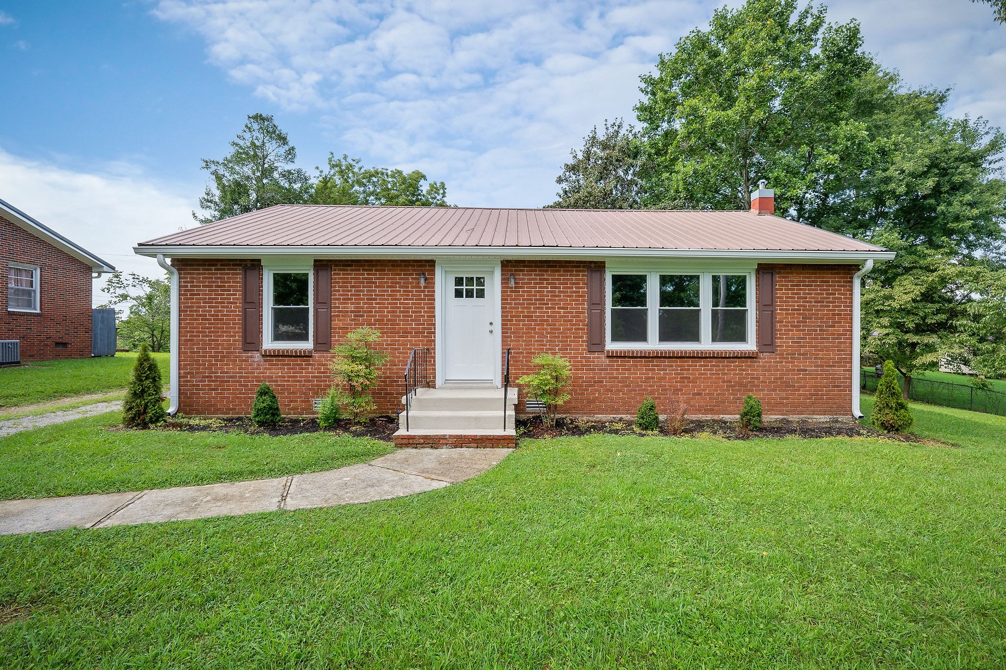 218 Roosevelt Road McMinnville, TN 37110 - Photo 2 of 31 a front view of a house with a garden