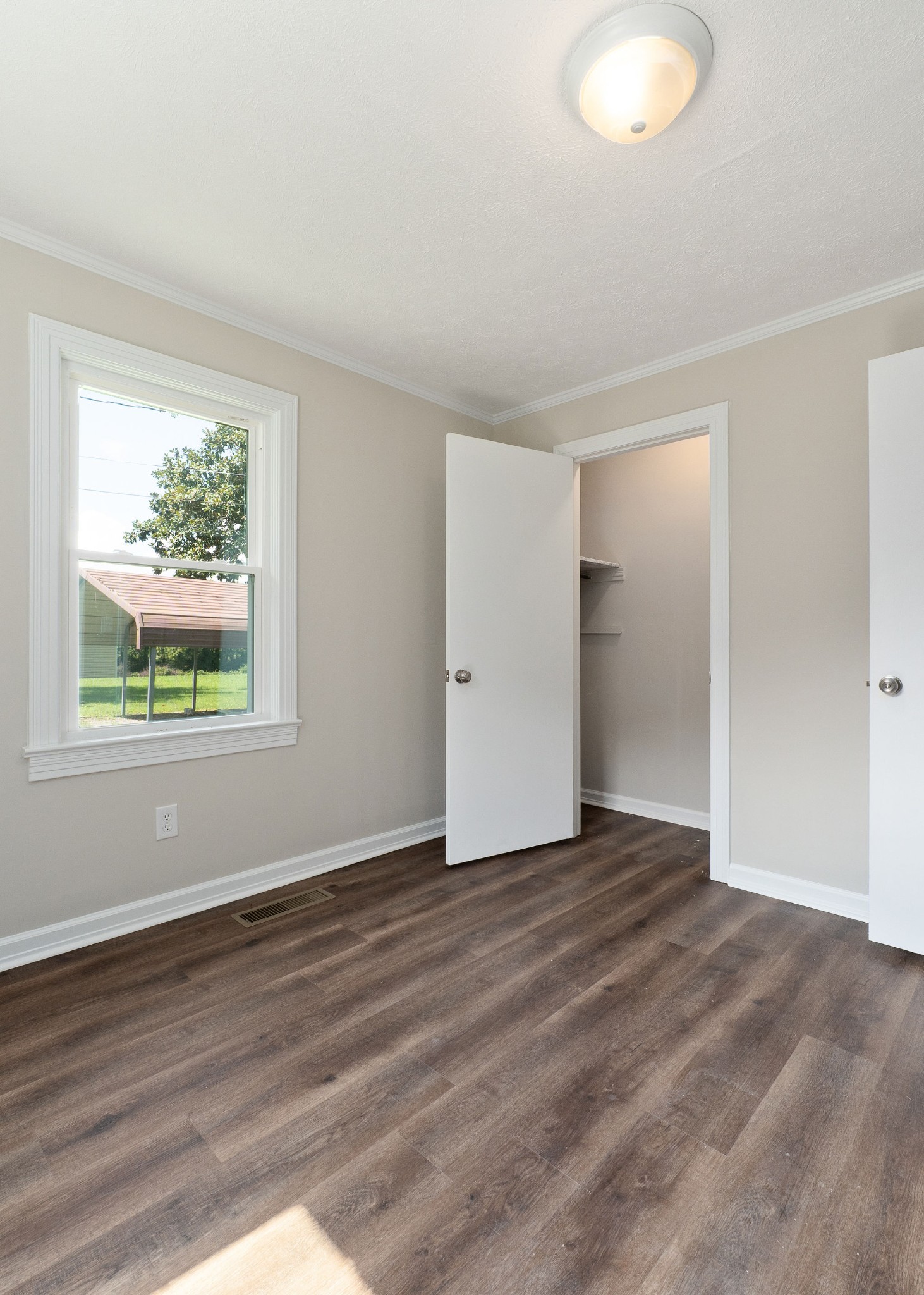 218 Roosevelt Road McMinnville, TN 37110 - Photo 29 of 31 a view of an empty room with wooden floor and a window