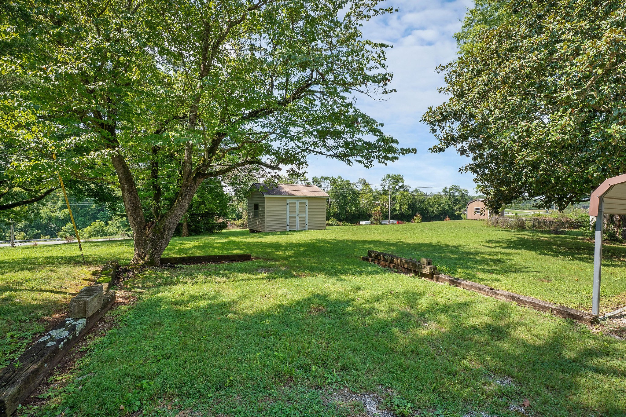 218 Roosevelt Road McMinnville, TN 37110 - Photo 30 of 31 a view of a house with yard and tree s