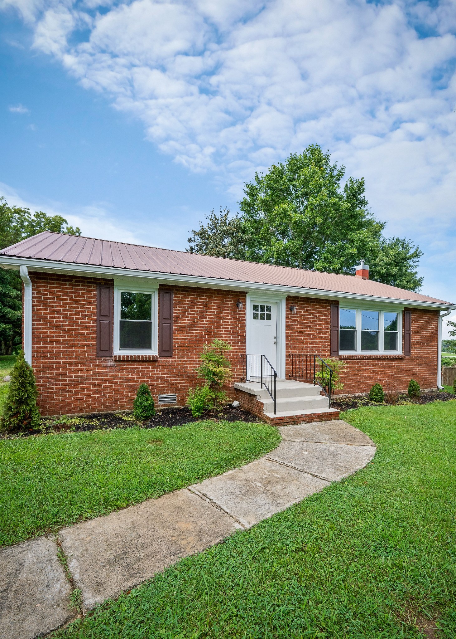 218 Roosevelt Road McMinnville, TN 37110 - Photo 3 of 31 a front view of a house with a yard and trees
