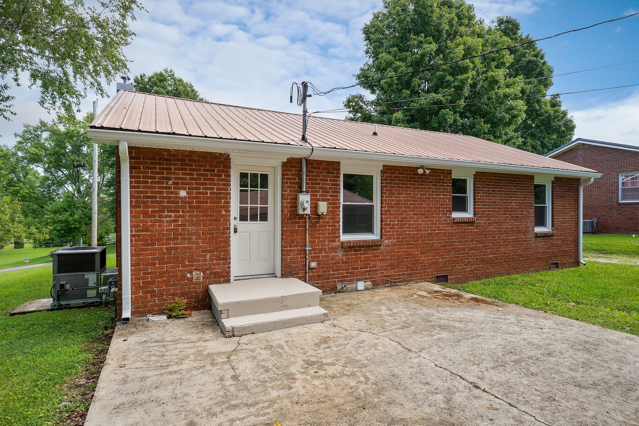 218 Roosevelt Road McMinnville, TN 37110 - Photo 4 of 31 a front view of a house with a garden and trees