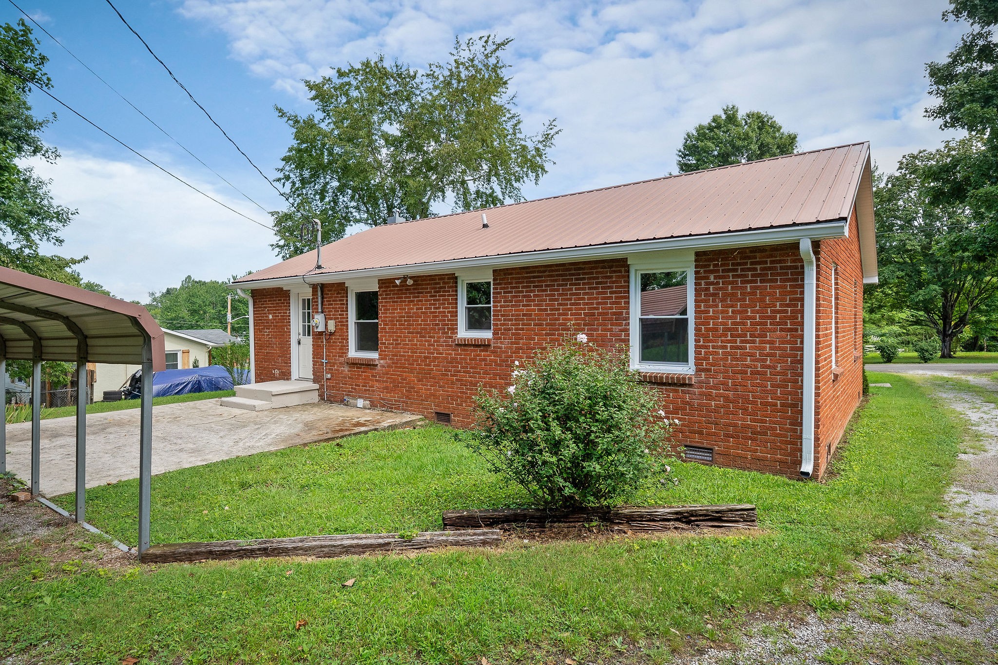 218 Roosevelt Road McMinnville, TN 37110 - Photo 5 of 31 a view of a house with a yard plants and large tree