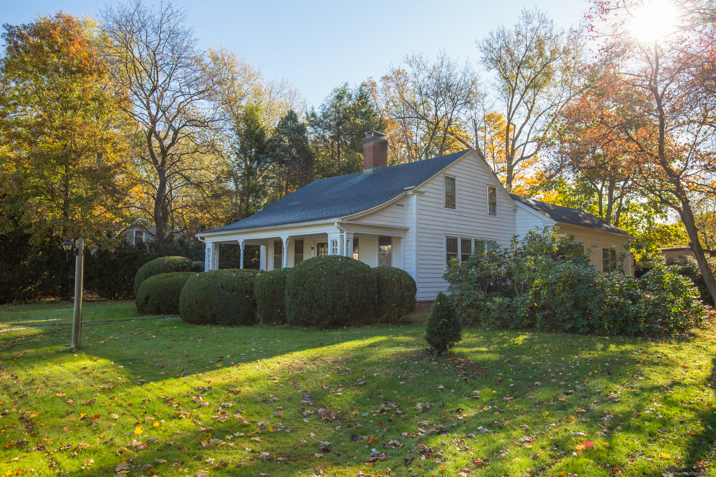 a front view of a house with yard and green space