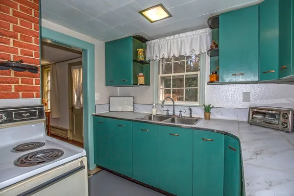 a kitchen with kitchen island a sink stove and cabinets