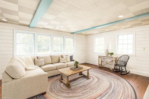 a living room with furniture a window and a table
