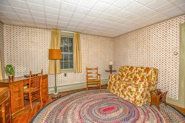 a bedroom with a bed and a chair