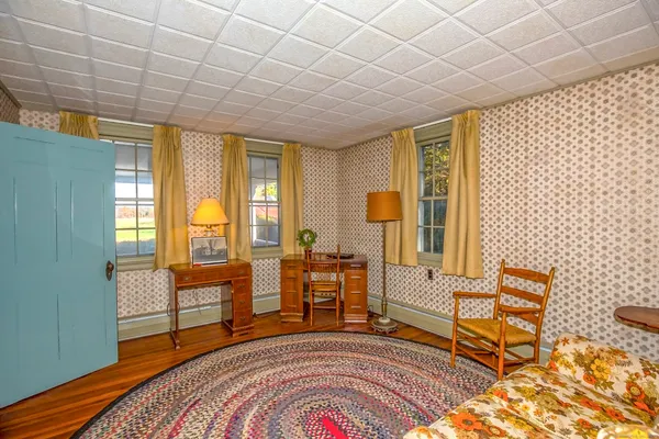 a bedroom with furniture and a large window