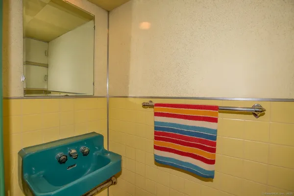 a room with a chair and painted walls