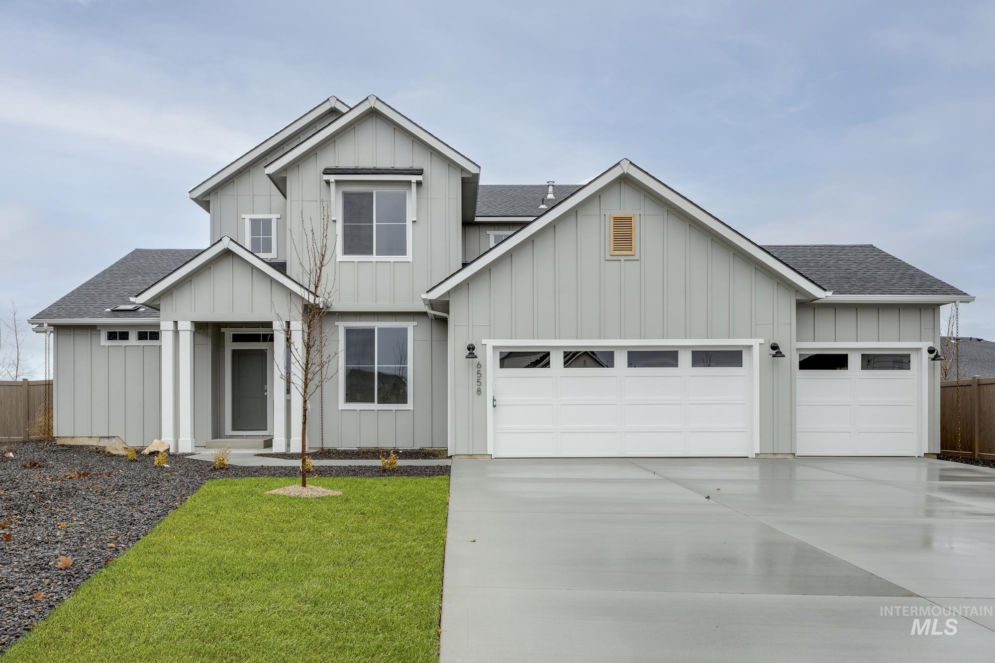 6558 South Sunfish Avenue Boise, ID 83709 - Photo 1 of 32 View of front of house with a shingled roof and board and batten siding