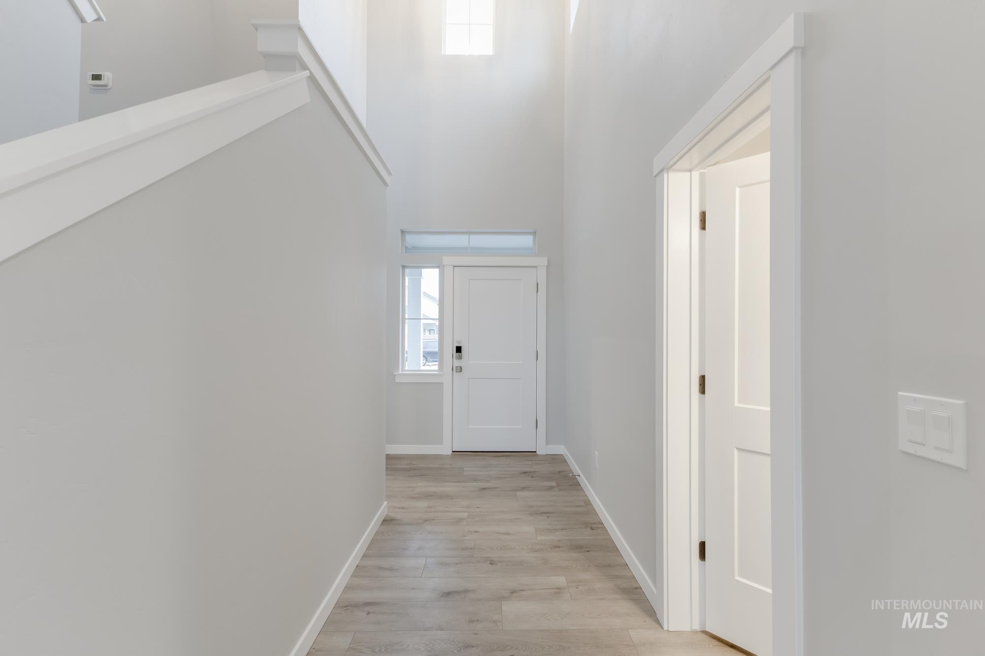 6558 South Sunfish Avenue Boise, ID 83709 - Photo 2 of 32 Doorway to outside featuring a high ceiling and wood finished floors