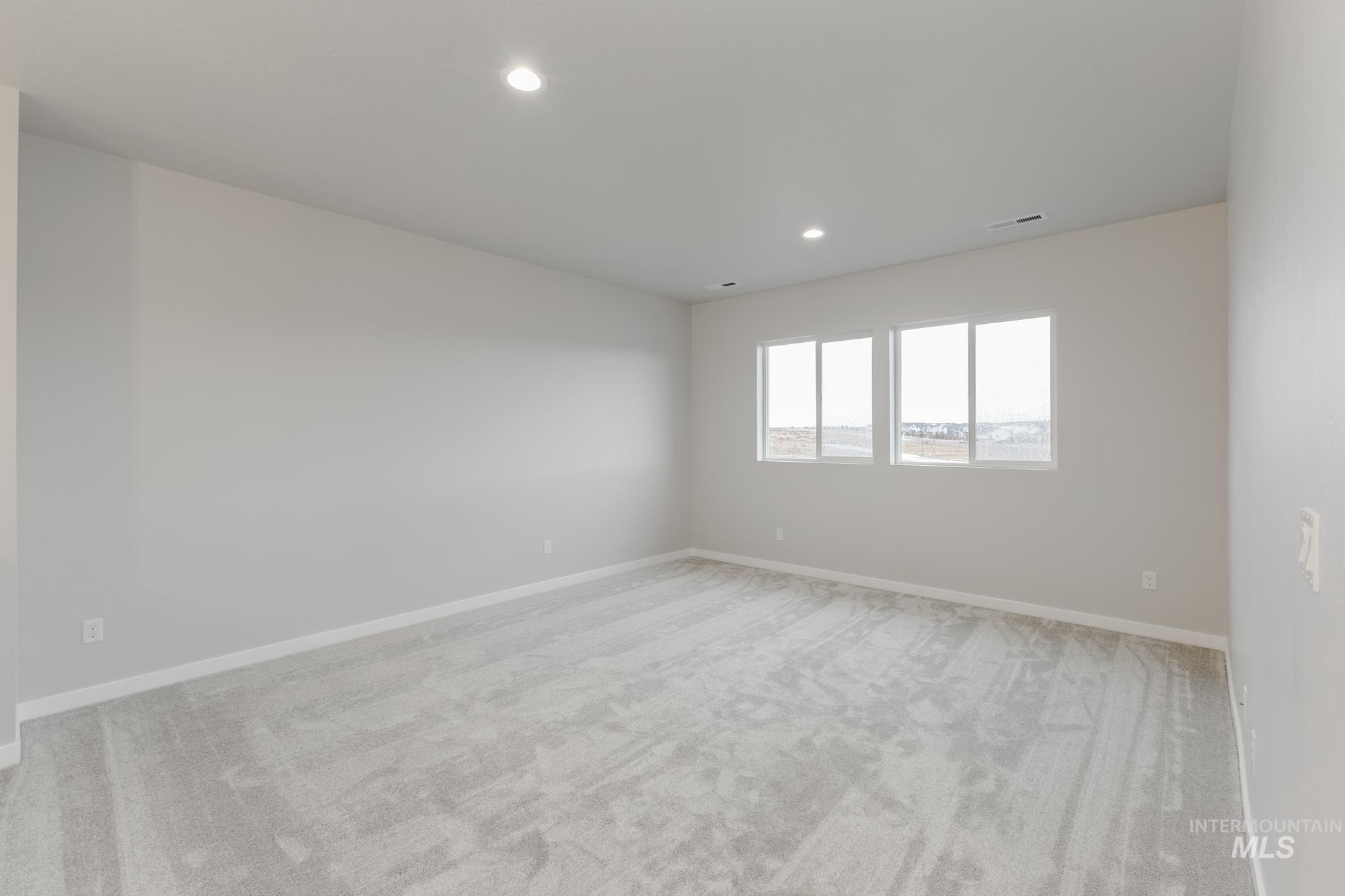 6558 South Sunfish Avenue Boise, ID 83709 - Photo 20 of 32 Spare room with light colored carpet and recessed lighting