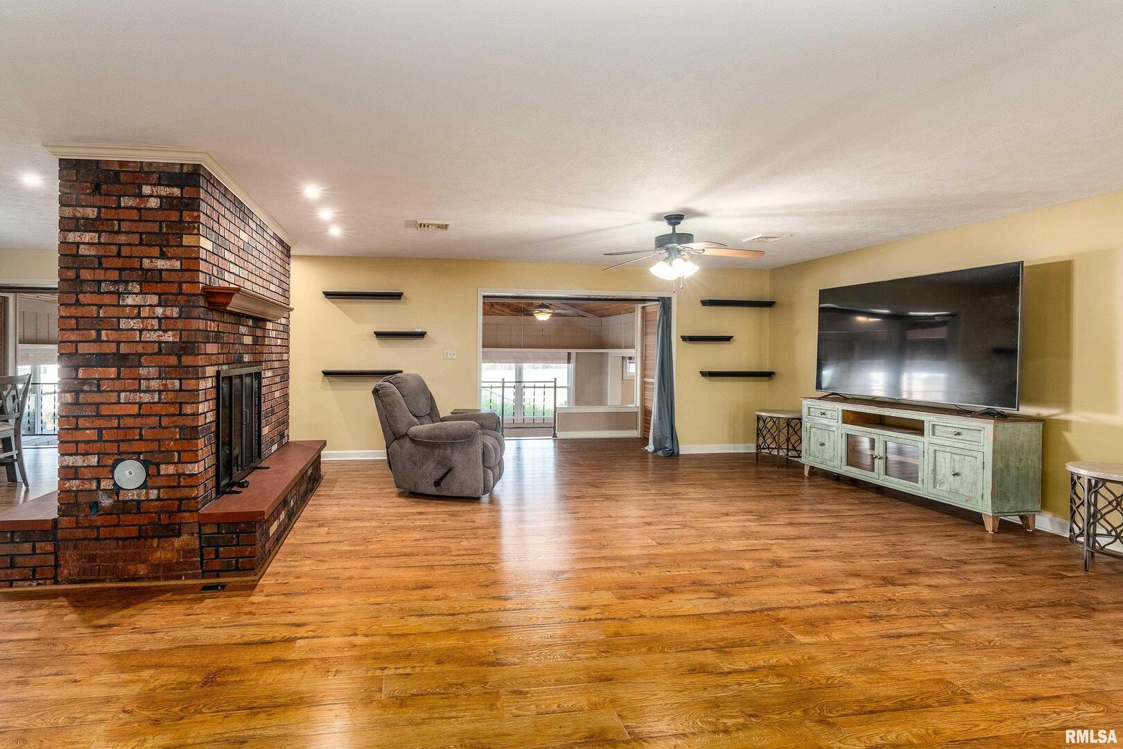9784 Highway 127 Murphysboro, IL 62966 - Photo 11 of 60 a living room with fireplace furniture and a flat screen tv