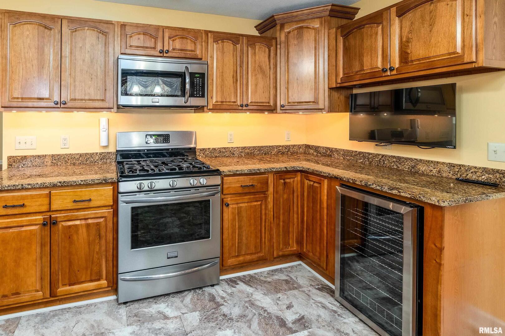 9784 Highway 127 Murphysboro, IL 62966 - Photo 16 of 60 a kitchen with granite countertop a stove top oven microwave and cabinets