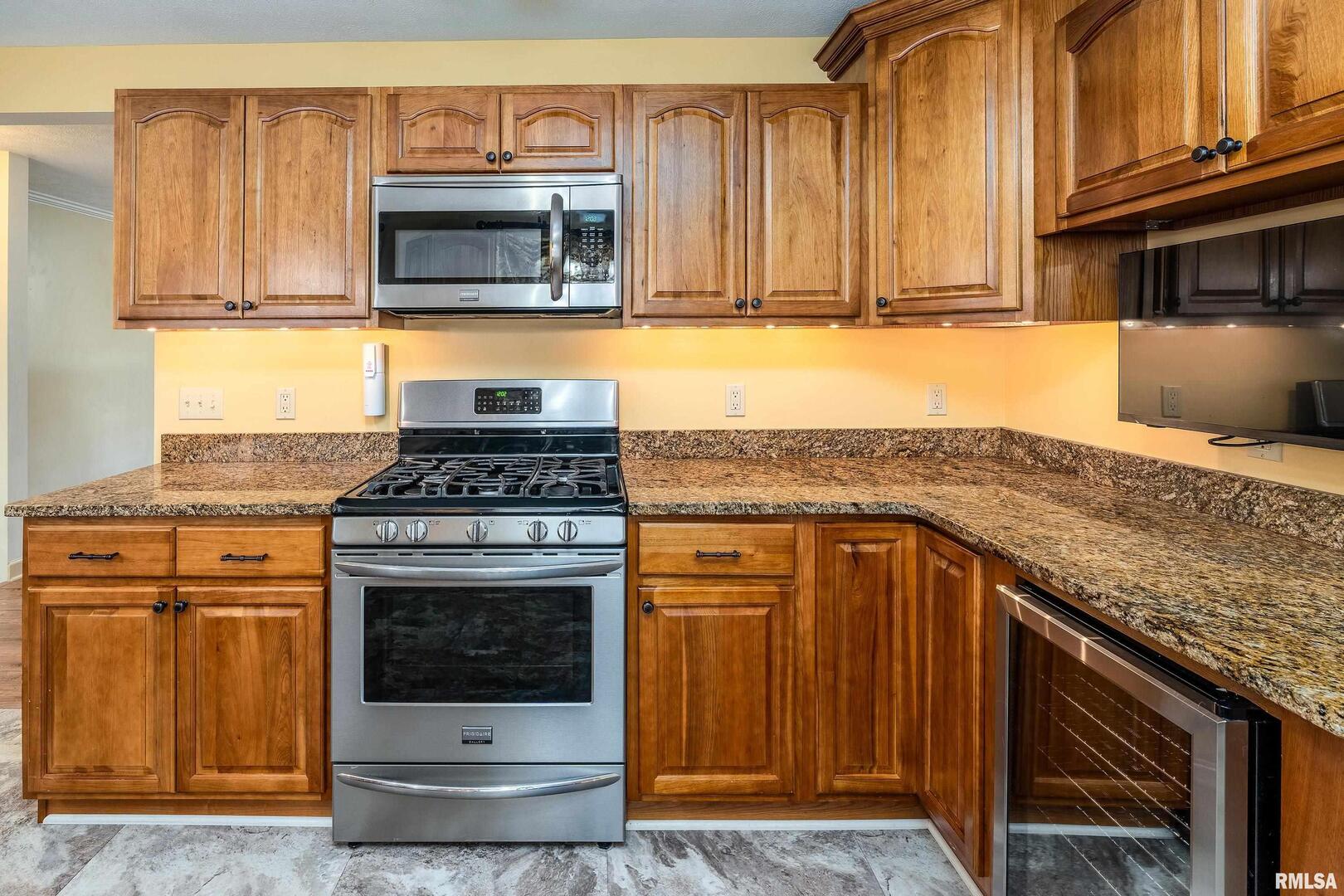9784 Highway 127 Murphysboro, IL 62966 - Photo 17 of 60 a kitchen with granite countertop a stove top oven cabinetry a sink and dishwasher