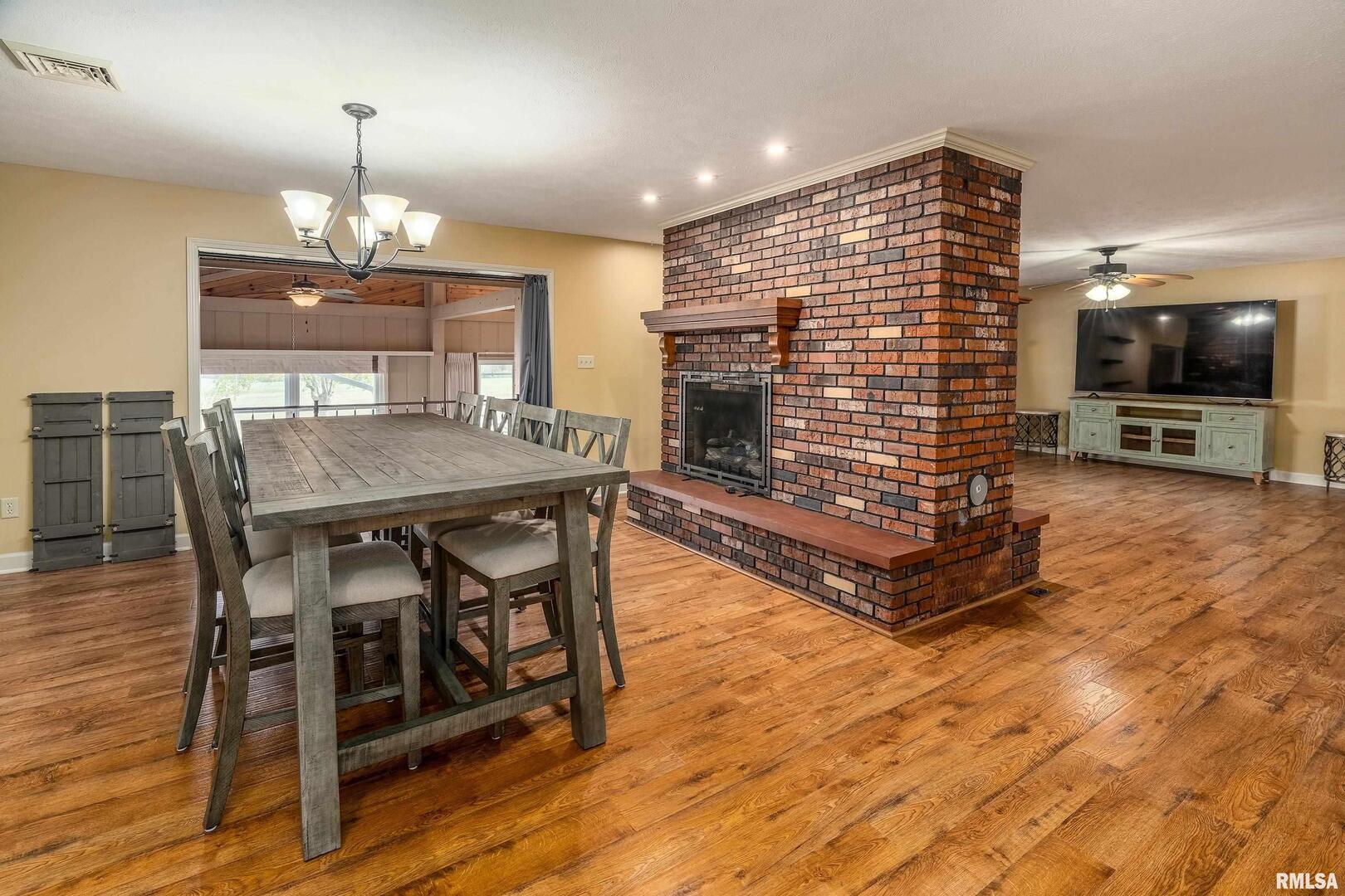 9784 Highway 127 Murphysboro, IL 62966 - Photo 20 of 60 a view of a dining room with furniture and wooden floor