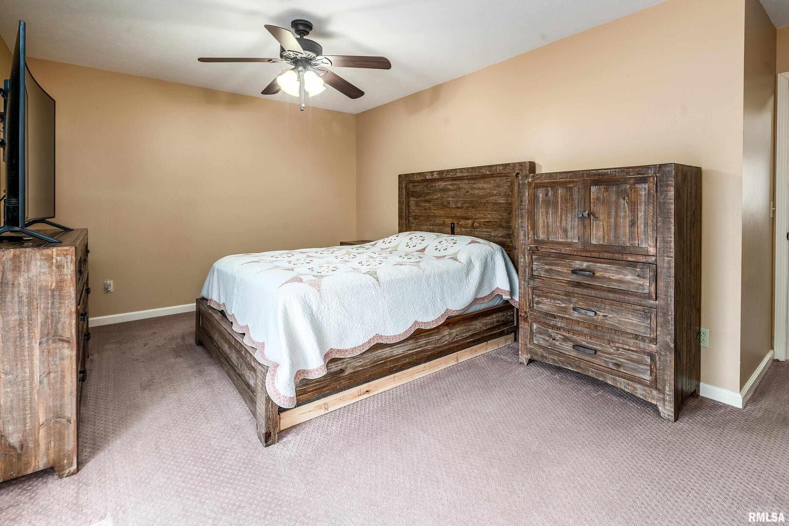 9784 Highway 127 Murphysboro, IL 62966 - Photo 27 of 60 a bedroom with a bed and a chandelier