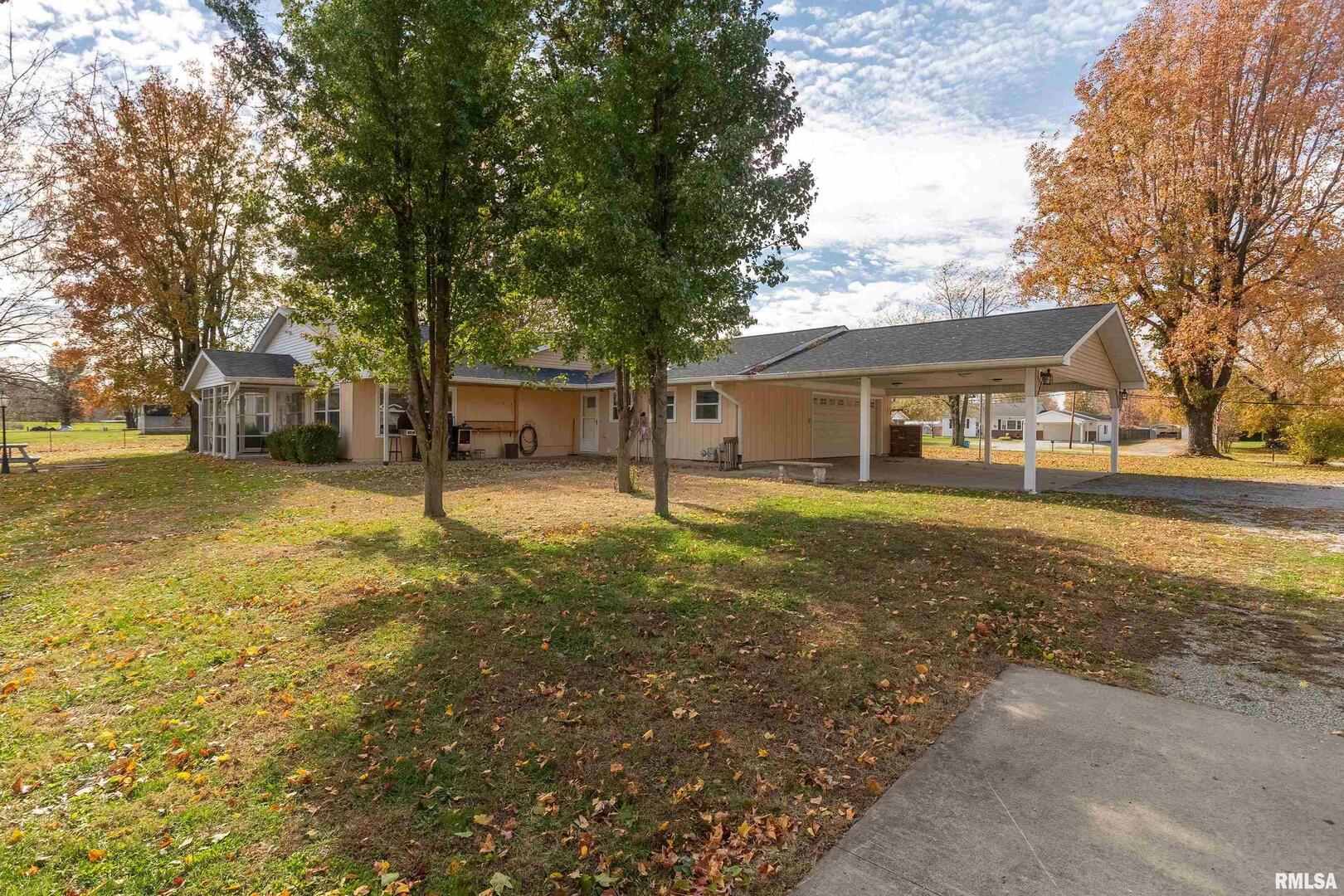9784 Highway 127 Murphysboro, IL 62966 - Photo 44 of 60 a view of a yard with a house and trees in the background