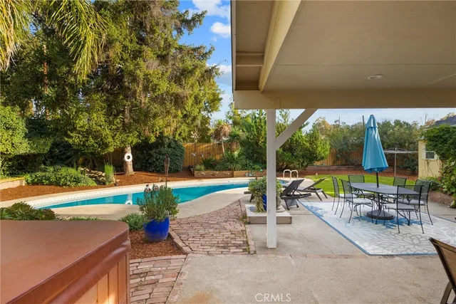 an aerial view of a house with swimming pool and garden