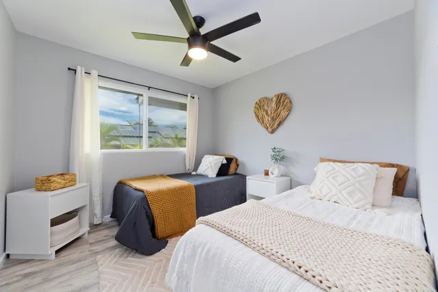 a bedroom with a large bed and a window