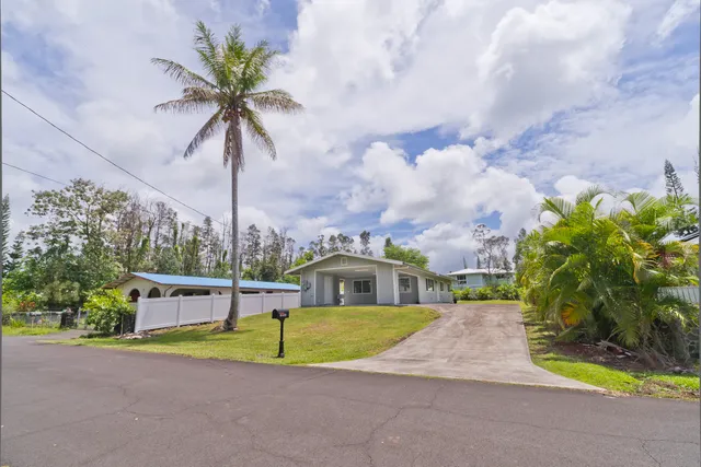 a view of a house with swimming pool and sitting area