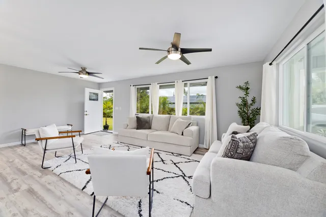 a living room with furniture and kitchen view