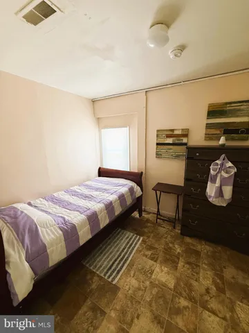 a bedroom with a bed and dresser