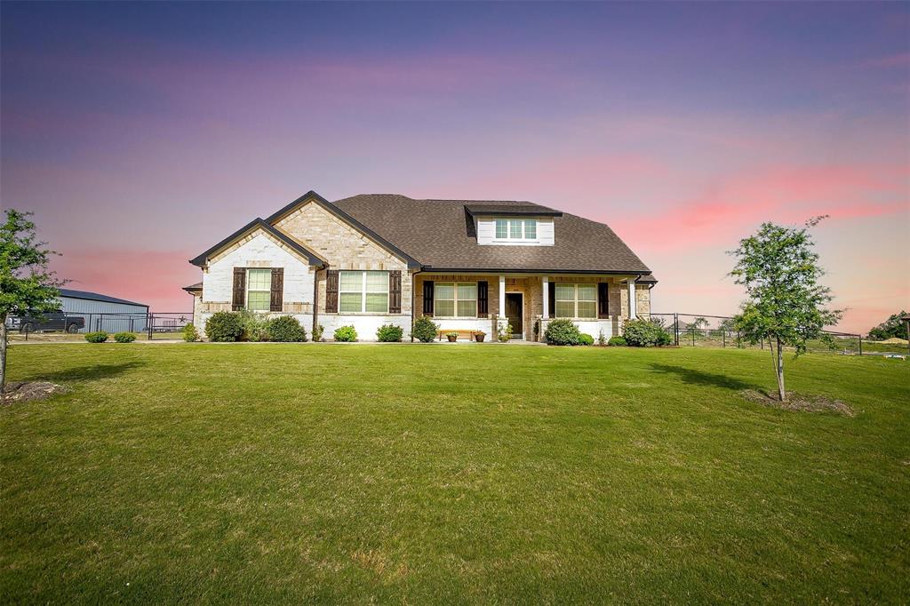 340 Sanger Drive Springtown, TX 76082 - Photo 1 of 38 a front view of a house with a garden