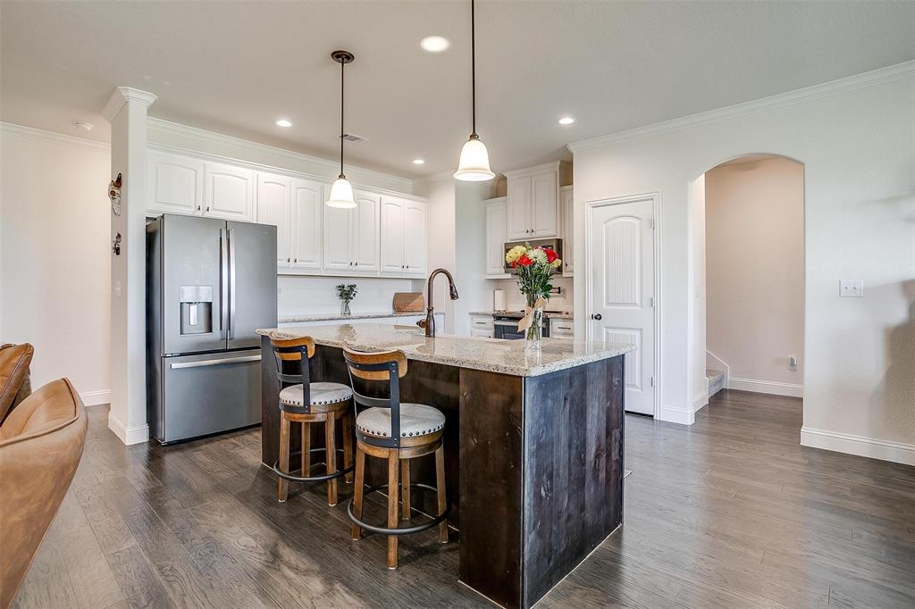 340 Sanger Drive Springtown, TX 76082 - Photo 13 of 38 a kitchen with kitchen island granite countertop a sink cabinets and stainless steel appliances