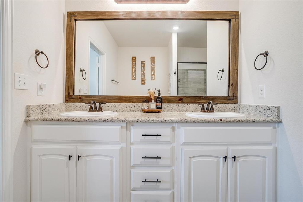 340 Sanger Drive Springtown, TX 76082 - Photo 20 of 38 a bathroom with a granite countertop sink and a mirror