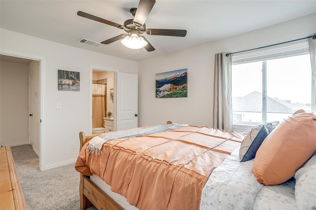 340 Sanger Drive Springtown, TX 76082 - Photo 27 of 38 a bedroom with a large bed and a window